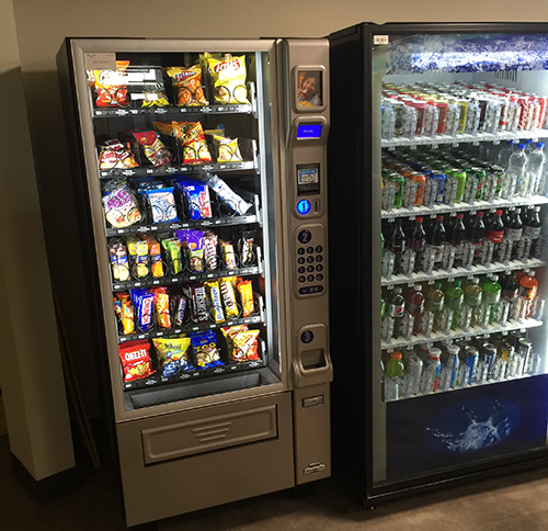 A snack machine on the left and a drink machine on the right