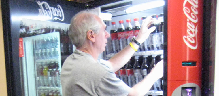 A man restocks a vending machine.